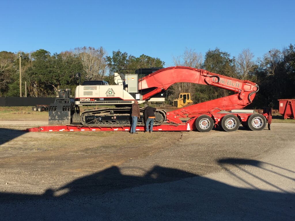 Excavator being loaded on a trailer.